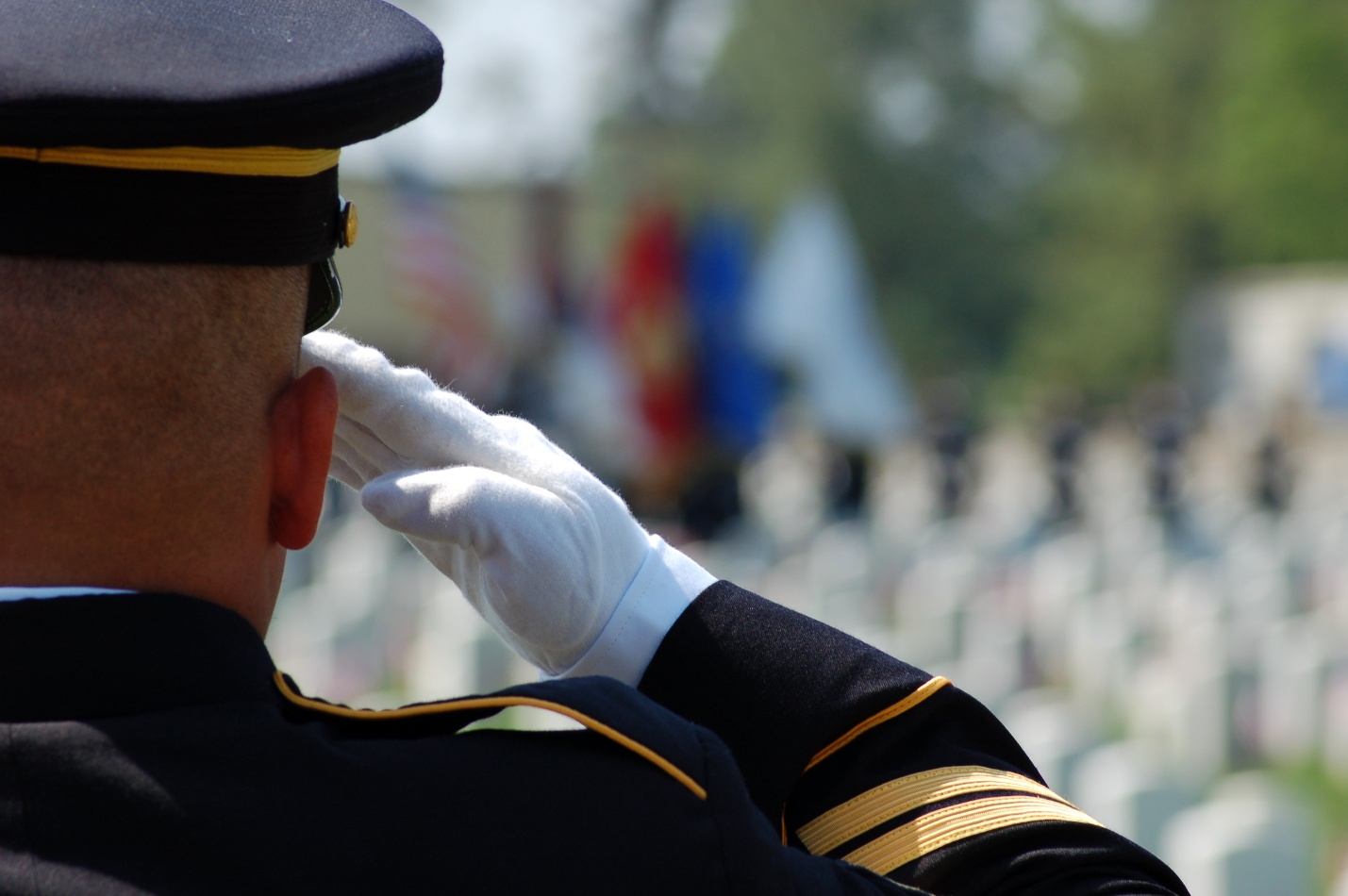 Person in military uniform saluting