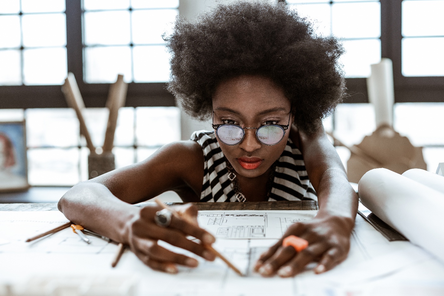 Woman drawing up blueprint